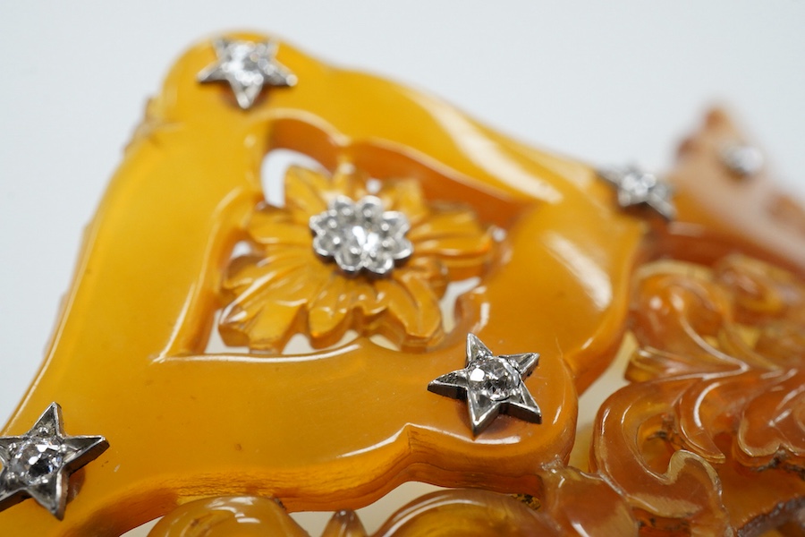 An early 20th century tortoiseshell hair comb set with eleven diamonds, 99mm by 83mm.